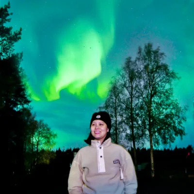 Lapland Escape founder under the Northern Lights in Rovaniemi, Finland, during an Arctic winter experience