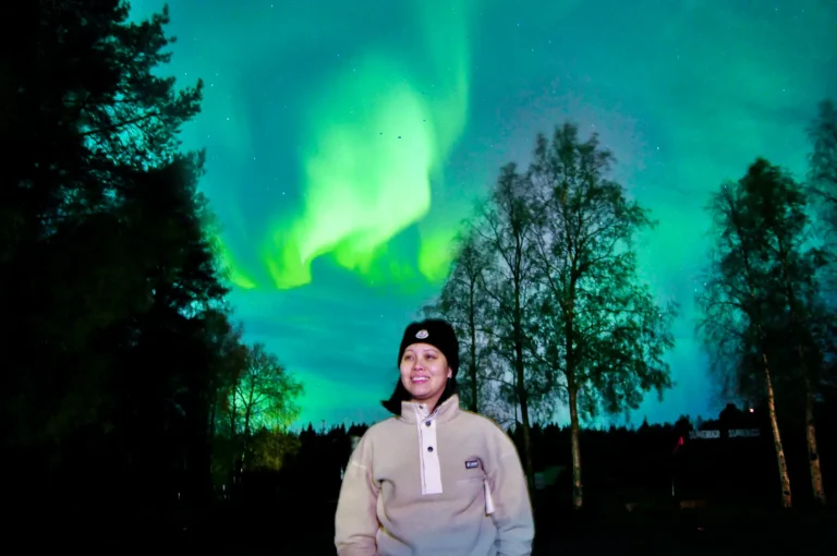 Lapland Escape founder under the Northern Lights in Rovaniemi, Finland, during an Arctic winter experience